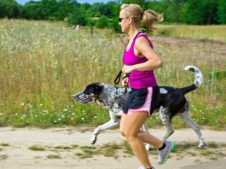 Woman running and walking a dog